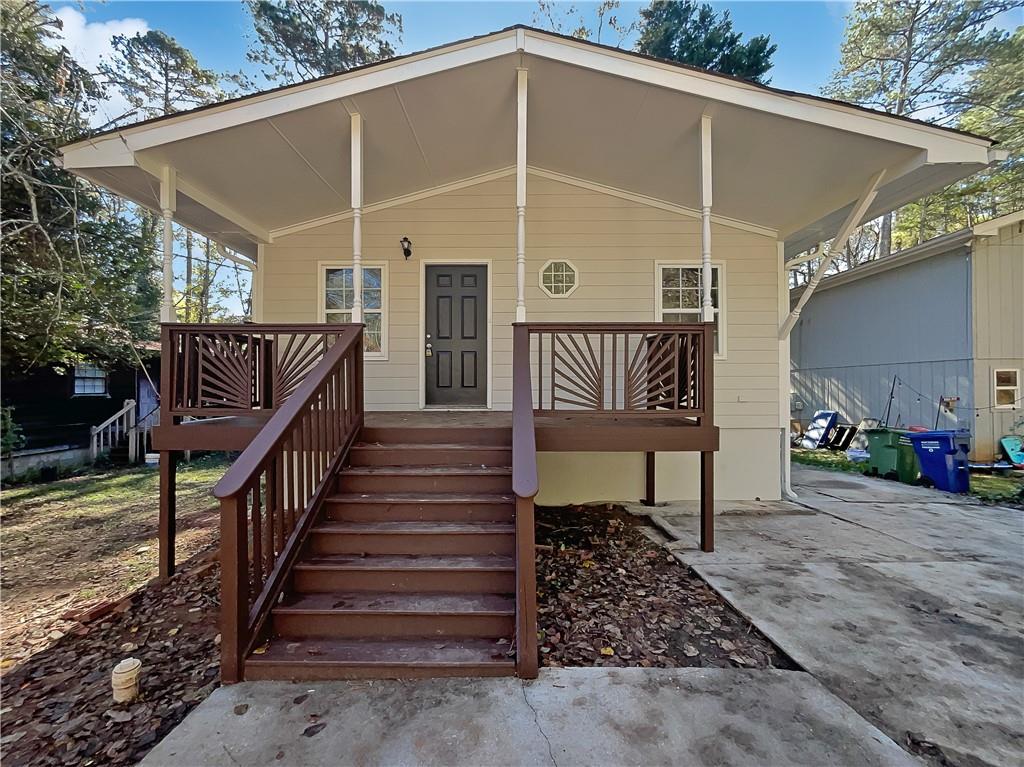4425 Amy Road Snellville, GA 30039 - Photo 1 of 19 a view of a porch with wooden floor and stairs