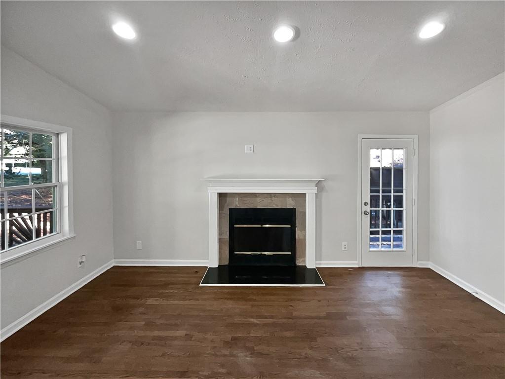 4425 Amy Road Snellville, GA 30039 - Photo 4 of 19 an empty room with windows and fireplace