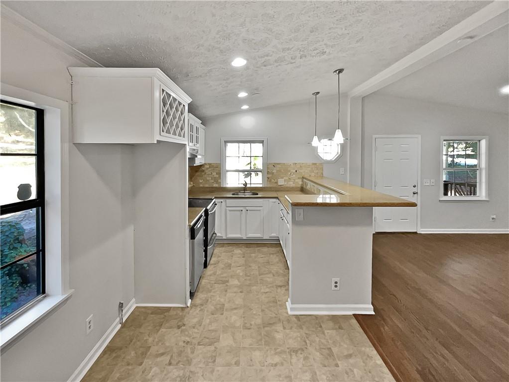 4425 Amy Road Snellville, GA 30039 - Photo 8 of 19 a kitchen with stainless steel appliances granite countertop a sink a stove and a refrigerator