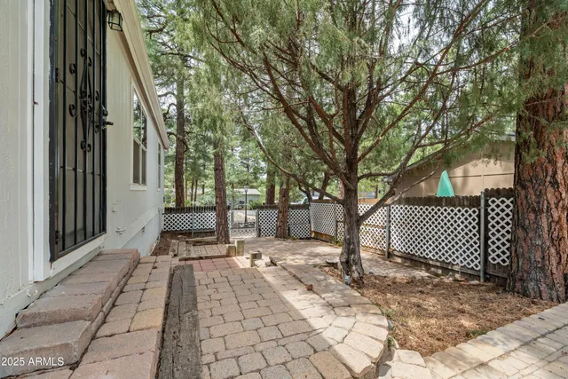 a patio with glass top table and chairs