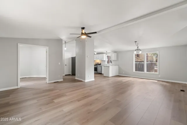 a kitchen with a stove and a wooden floors
