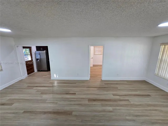 a kitchen with stainless steel appliances granite countertop a refrigerator and a stove