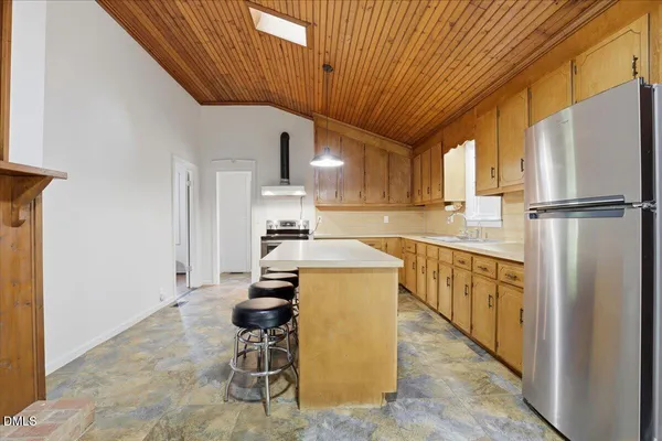 a kitchen with table and chairs