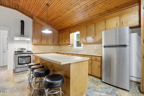 a kitchen with cabinets and chairs