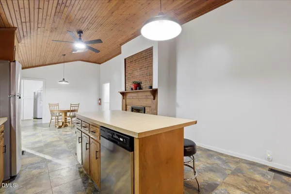 a kitchen with a stove a refrigerator and a stove top oven
