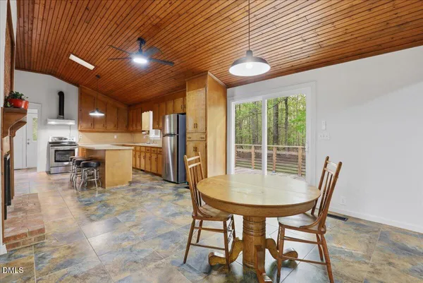 a kitchen with stainless steel appliances granite countertop a stove a sink dishwasher and a refrigerator