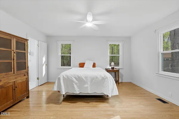a bedroom with a bed and a night stand