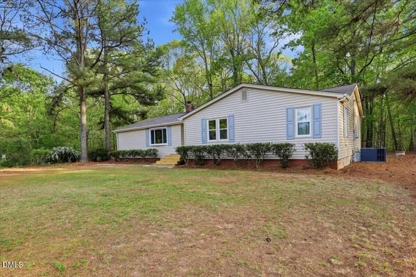 a front view of house with yard and trees