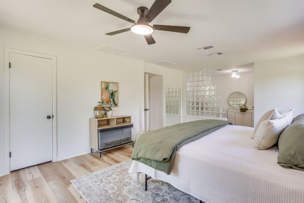 6345 Silver Creek Azle Road Azle, TX 76020 - Photo 22 of 40 a bedroom with a bed and a chandelier