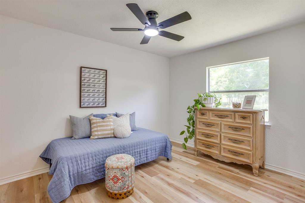 6345 Silver Creek Azle Road Azle, TX 76020 - Photo 24 of 40 a bedroom with a bed and wooden floor