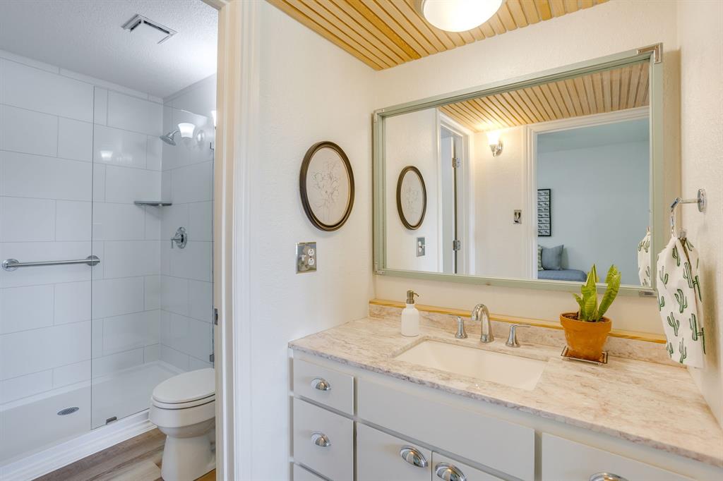 6345 Silver Creek Azle Road Azle, TX 76020 - Photo 25 of 40 a bathroom with a granite countertop sink a toilet and shower