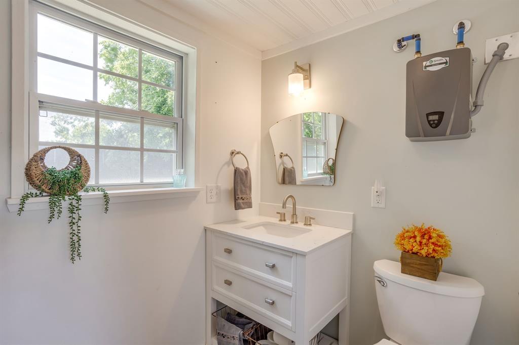 6345 Silver Creek Azle Road Azle, TX 76020 - Photo 34 of 40 a bathroom with a toilet sink and mirror