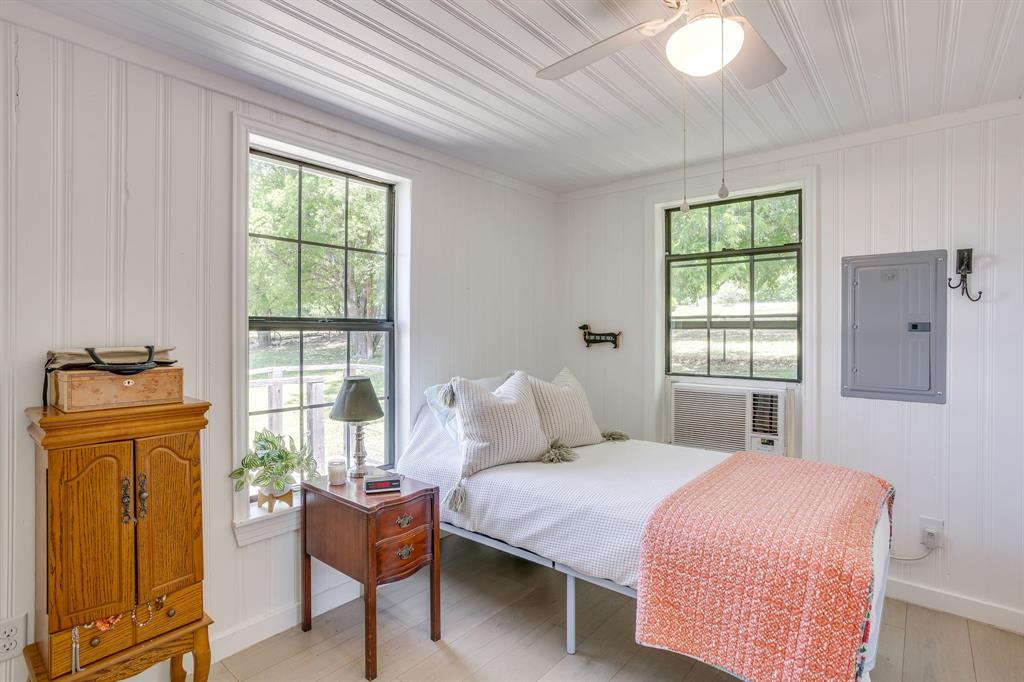 6345 Silver Creek Azle Road Azle, TX 76020 - Photo 36 of 40 a bedroom with a bed and wooden floor