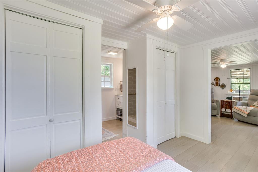 6345 Silver Creek Azle Road Azle, TX 76020 - Photo 37 of 40 a bedroom with a bed and a chandelier