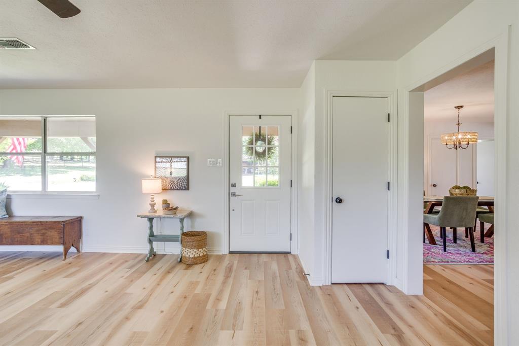 6345 Silver Creek Azle Road Azle, TX 76020 - Photo 8 of 40 a view of a livingroom with wooden floor and a window