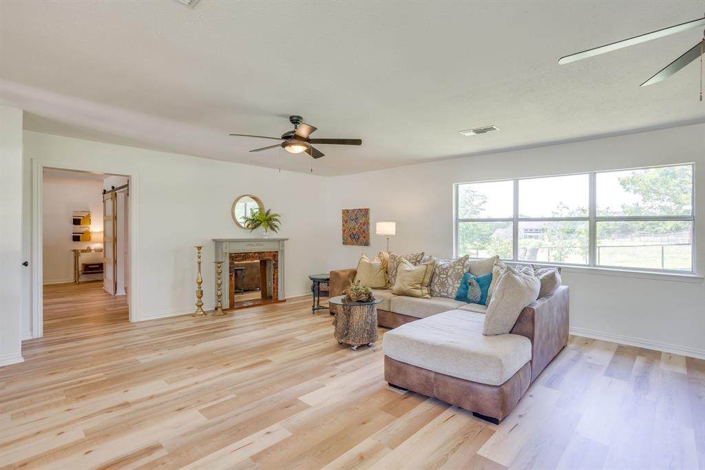 6345 Silver Creek Azle Road Azle, TX 76020 - Photo 10 of 40 a living room with fireplace furniture and a wooden floor