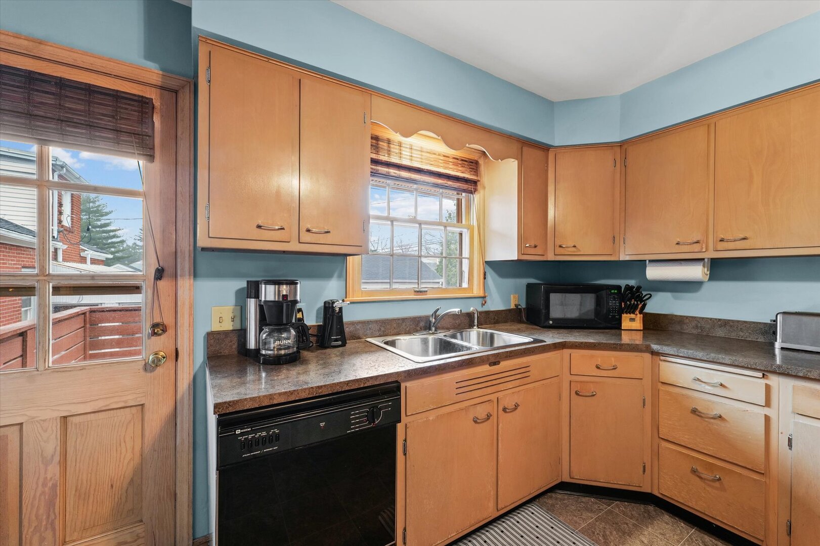 901 West Healey Street Champaign, IL 61821 - Photo 13 of 30 a kitchen with granite countertop cabinets stainless steel appliances a sink and window