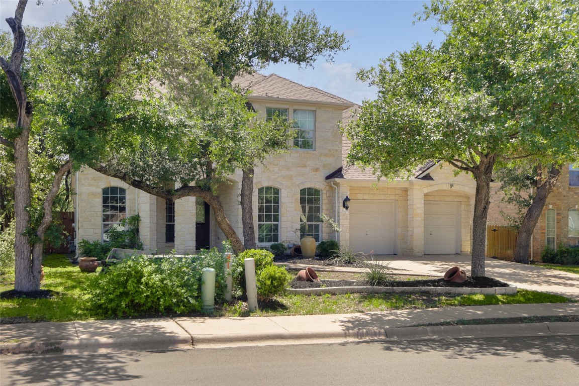 a front view of house with yard and trees