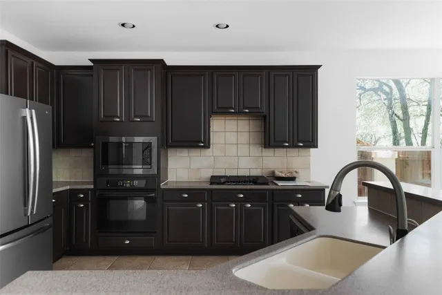 a kitchen with wooden cabinets a sink and a stove