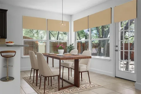 a view of a dining room with furniture large windows and wooden floor