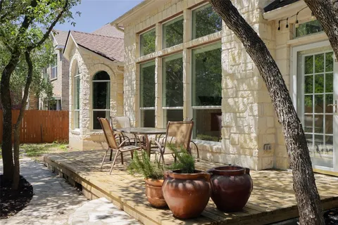 a view of a patio with table and chairs and potted plants