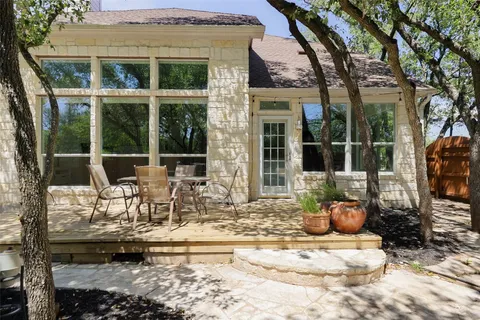 a view of a patio with table and chairs and potted plants