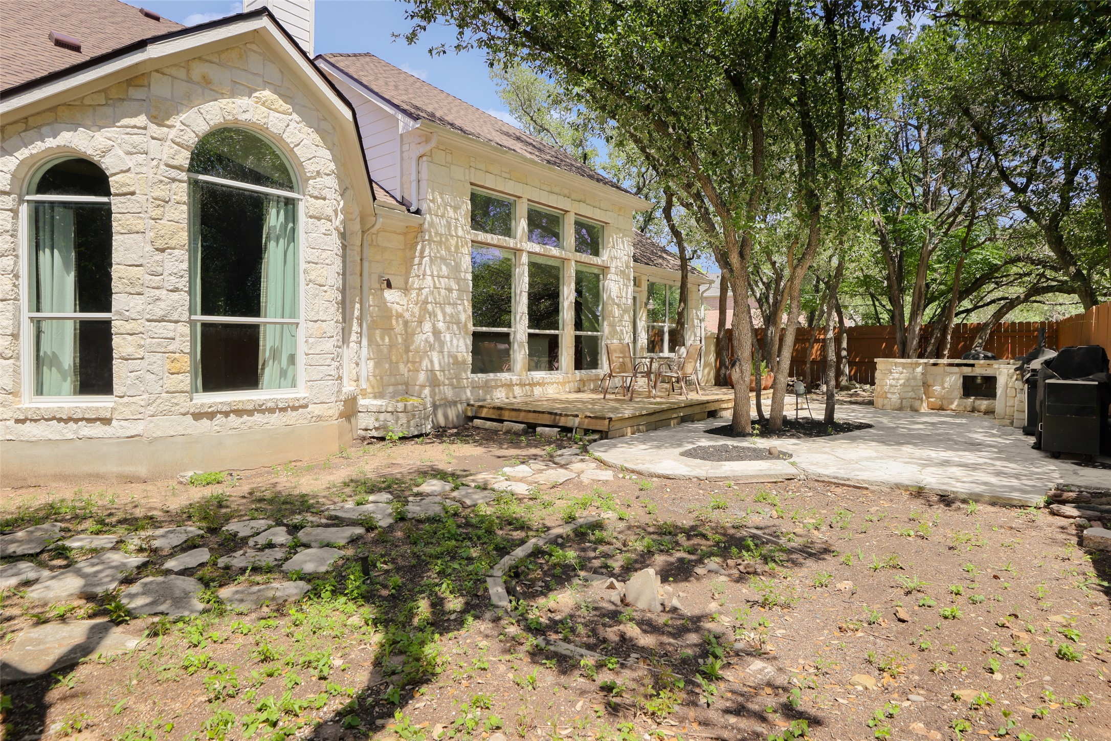 7921 Davis Mountain Pass Austin, TX 78726 - Photo 35 of 40 a view of a brick house with large windows