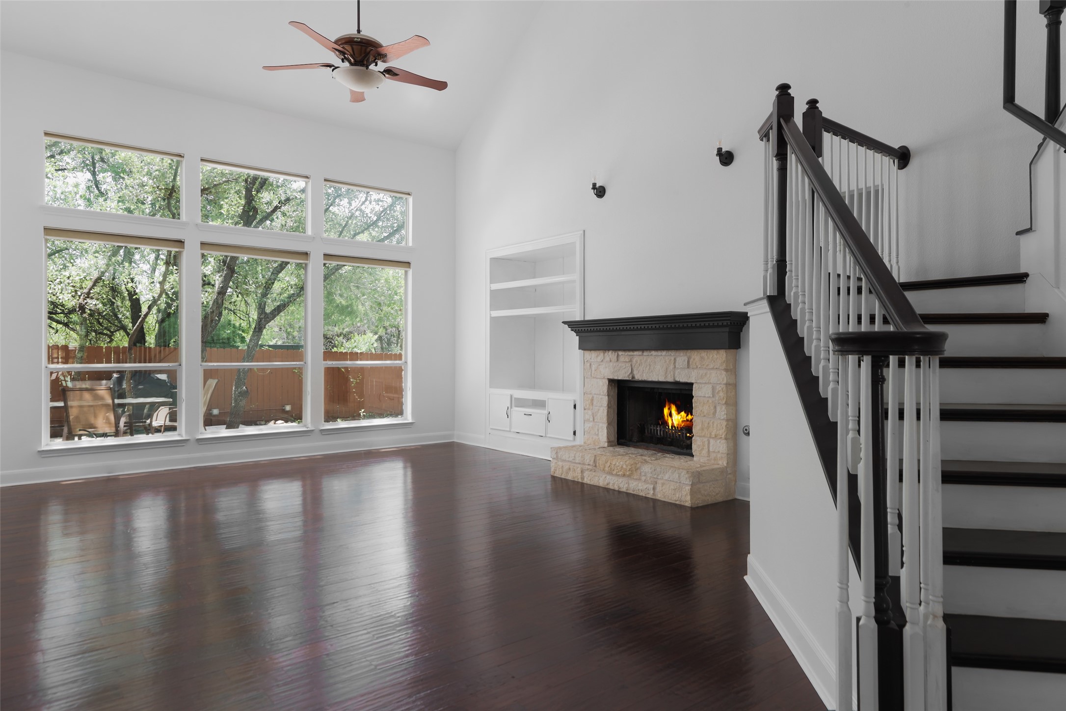 7921 Davis Mountain Pass Austin, TX 78726 - Photo 9 of 40 a view of an empty room with wooden floor fireplace and a window