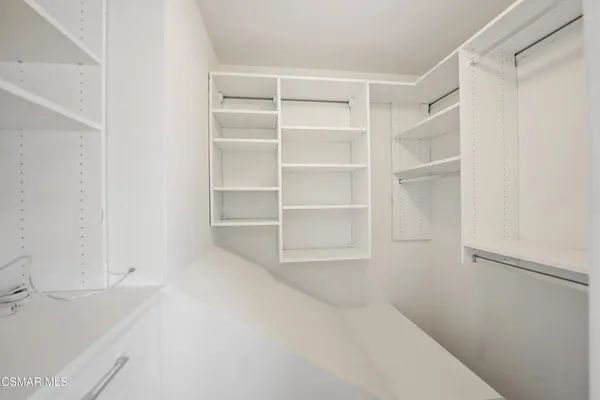 a bedroom with a bed and painting on the wall