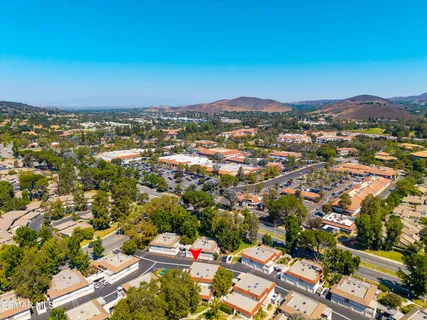 an aerial view of residential houses with city view