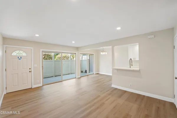 a view of an empty room with glass door