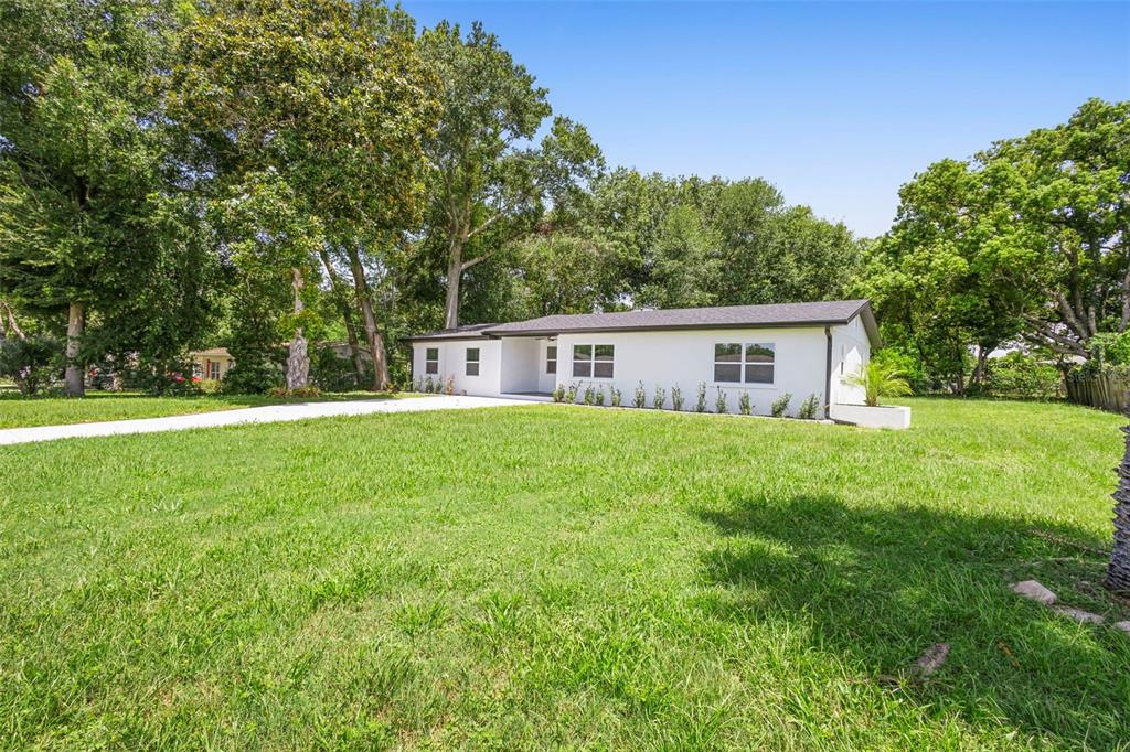 a front view of house with yard and green space