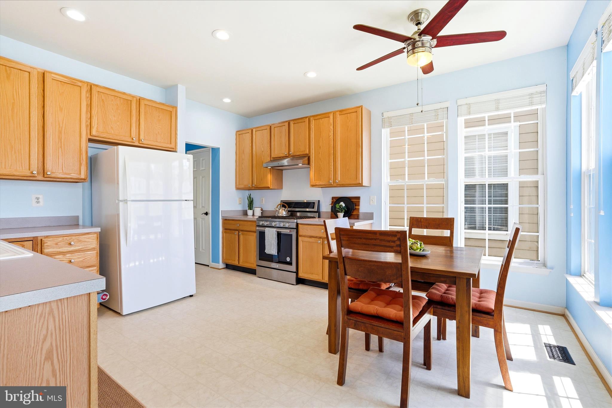 9009 Bealls Farm Road Frederick, MD 21704 - Photo 6 of 41 a kitchen with a refrigerator a table and chairs