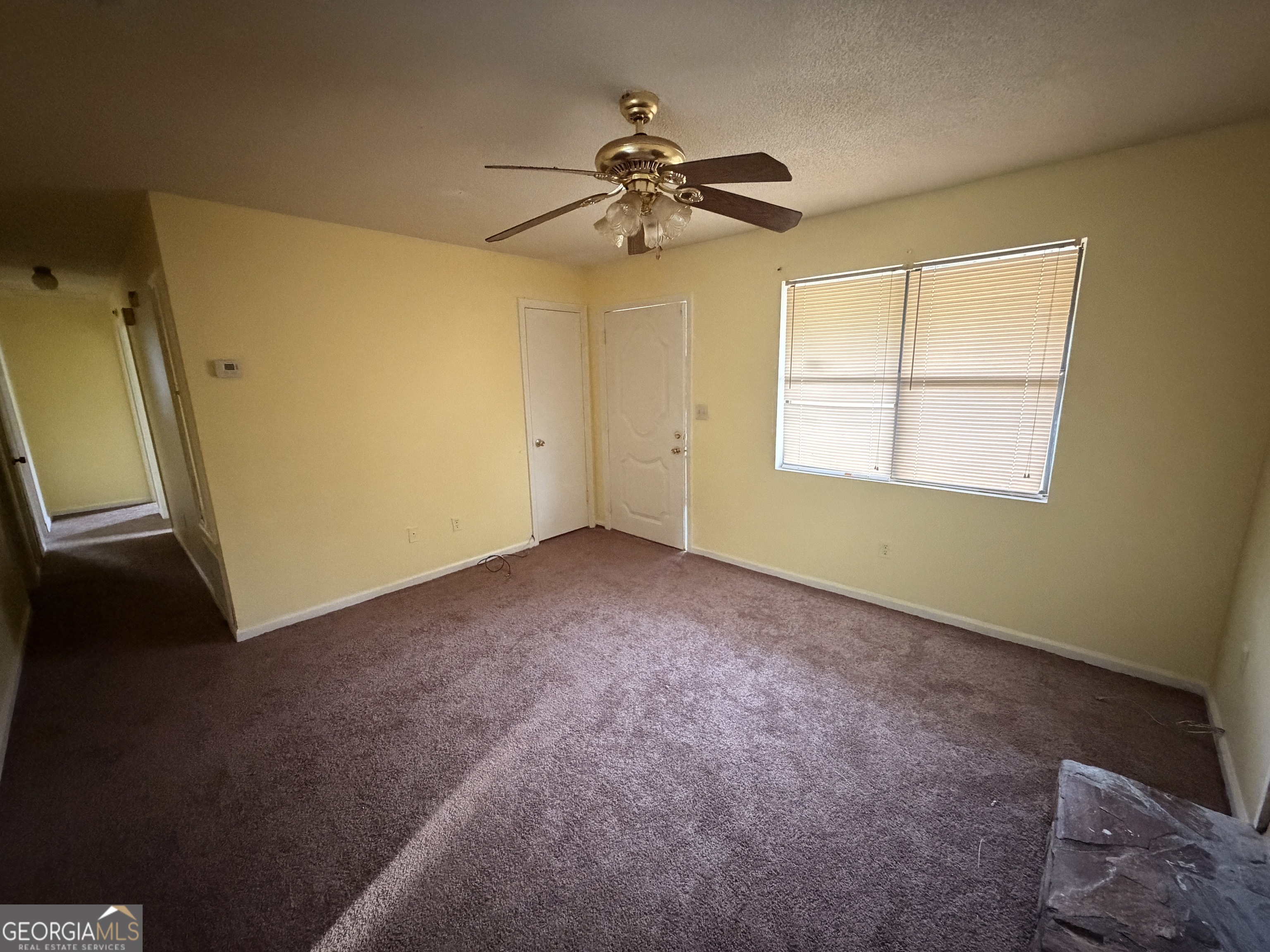 3523 Morgan Road Hephzibah, GA 30815 - Photo 2 of 15 an empty room with a ceiling fan and window