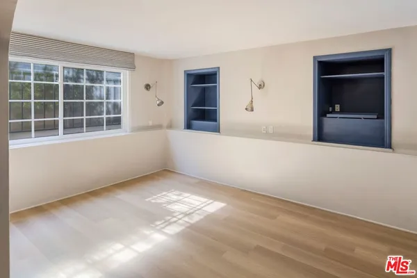 an empty room with windows and entrance