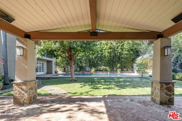 a view of a house with a backyard porch and sitting area