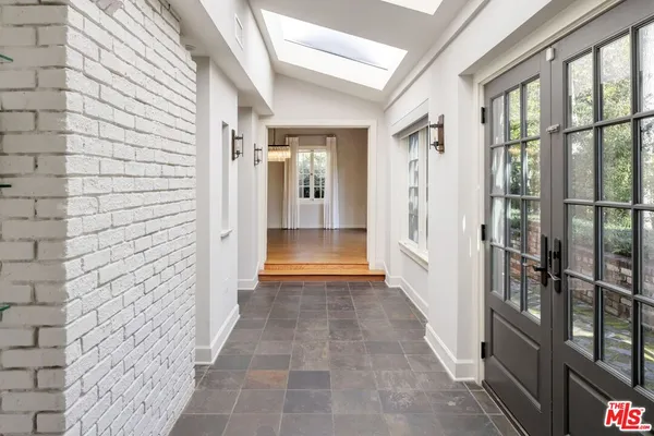 a view of a hallway with wooden shelves