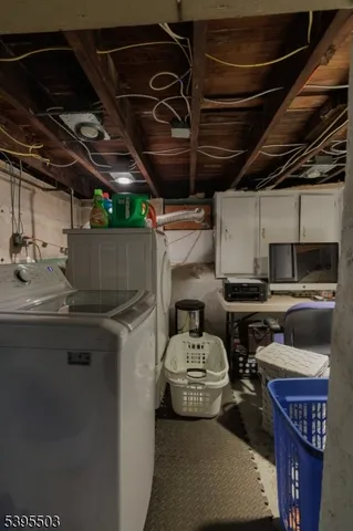 a utility room with stainless steel appliances a stove a sink and a washer