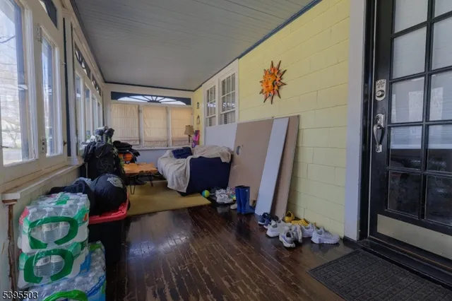 a living room with furniture or wooden floor and a large window