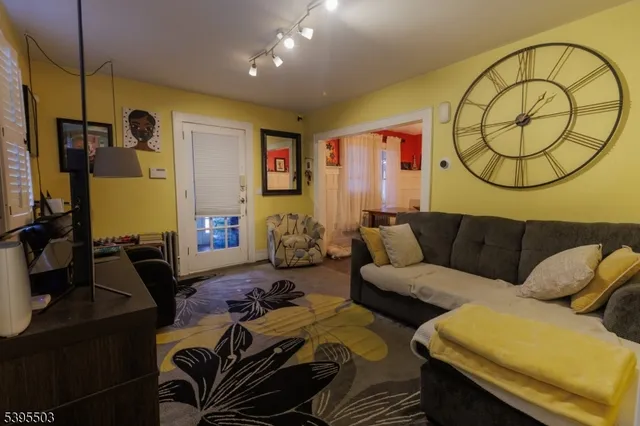 a living room with furniture a table and wooden floor