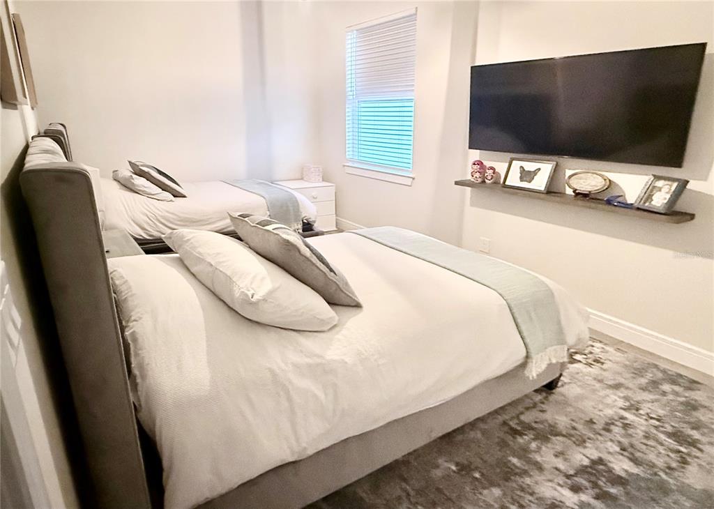 1994 Spring Shower Circle Kissimmee, FL 34744 - Photo 12 of 29 a bedroom with bed and flat screen tv