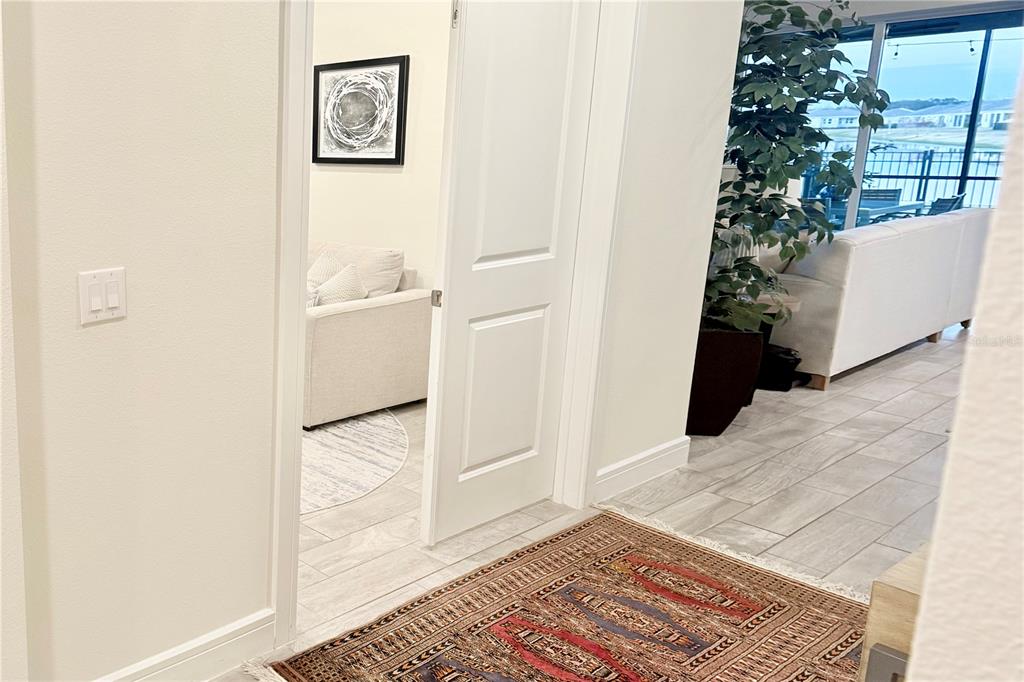 1994 Spring Shower Circle Kissimmee, FL 34744 - Photo 14 of 29 a view of a hallway with wooden floor and a dining room