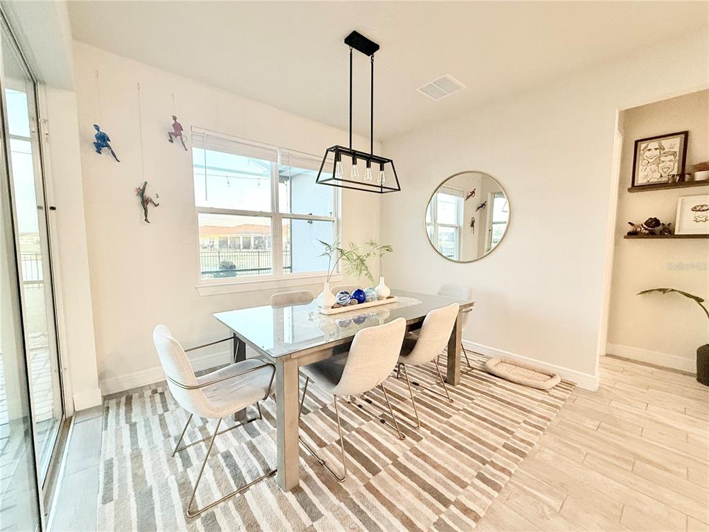 1994 Spring Shower Circle Kissimmee, FL 34744 - Photo 7 of 29 a view of a dining room with furniture window and wooden floor