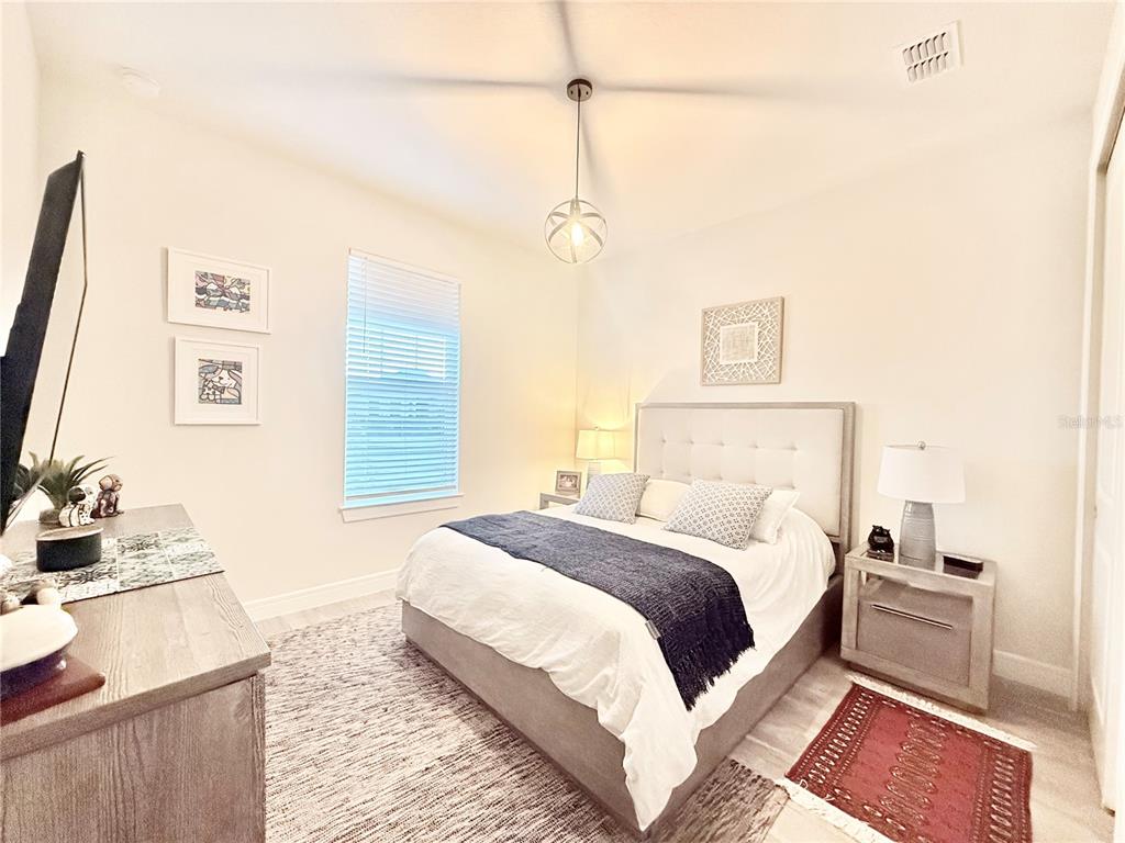 1994 Spring Shower Circle Kissimmee, FL 34744 - Photo 9 of 29 a bedroom with a bed and wooden floor