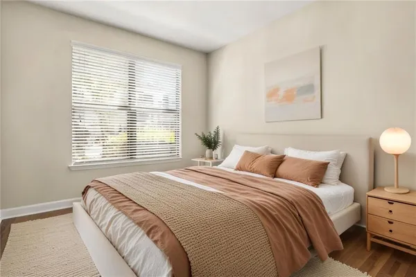 a bedroom with a bed and a window