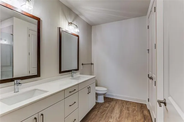 a bathroom with a double vanity sink and mirror with shower