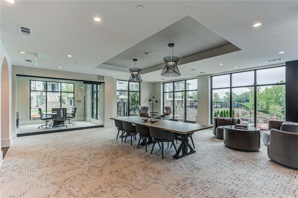 1003 Ridgewalk Parkway, Unit 4316 Woodstock, GA 30189 - Photo 32 of 38 a dining room with furniture a chandelier and a rug
