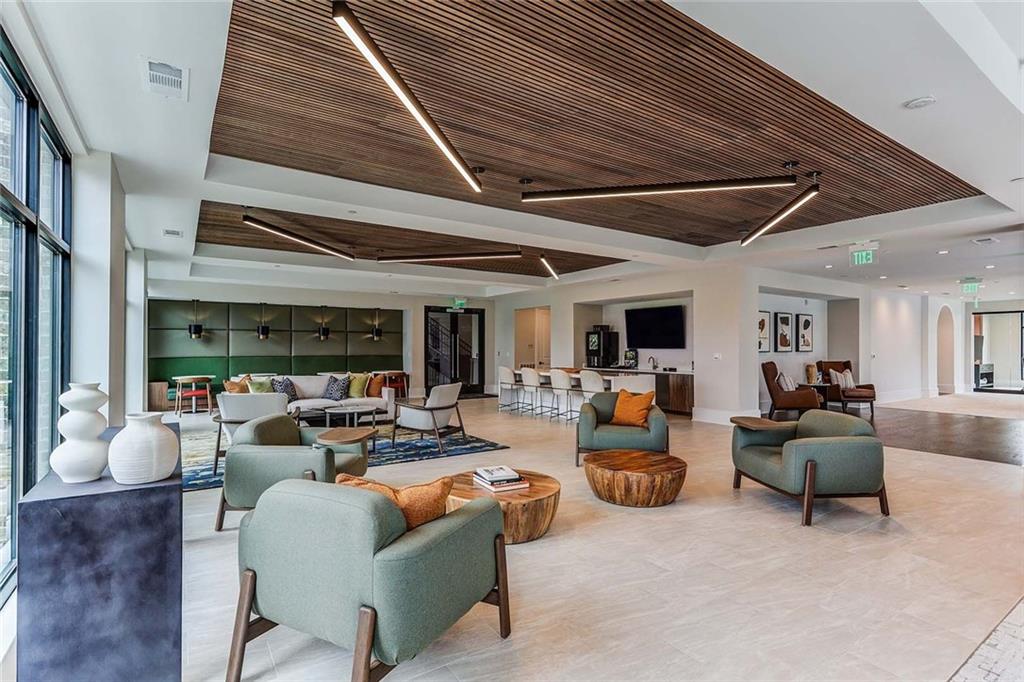 1003 Ridgewalk Parkway, Unit 4316 Woodstock, GA 30189 - Photo 33 of 38 a living room with furniture and a large window