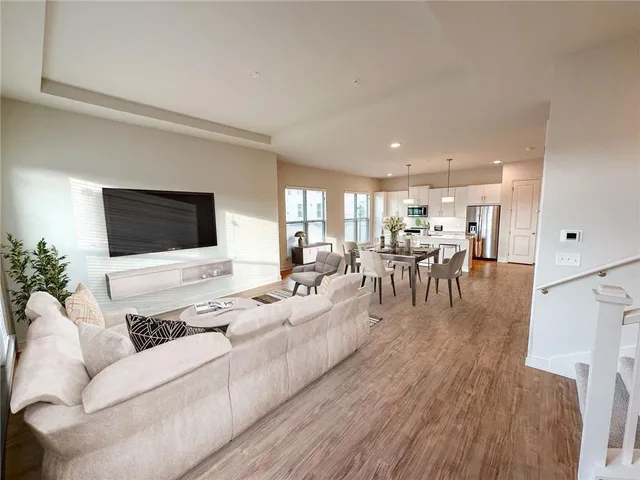 a living room with furniture wooden floor and a flat screen tv