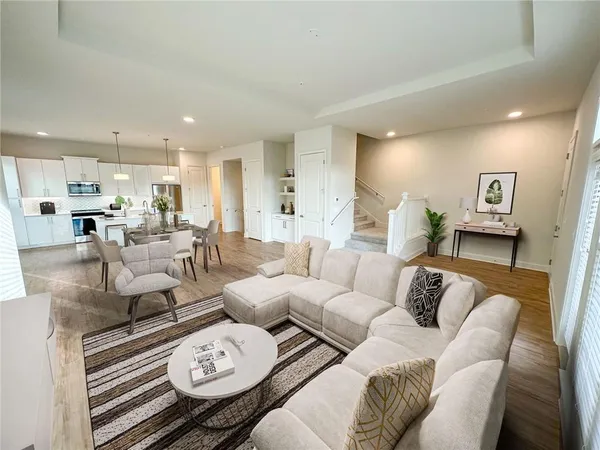 a living room with furniture and kitchen view